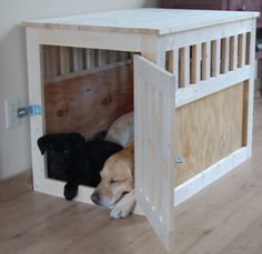 there is a dog that is laying down in the wooden crate with his head inside