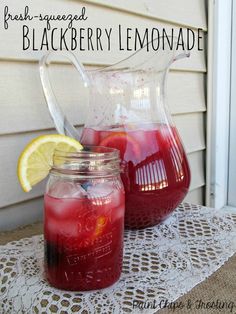 fresh squeezed blackberry lemonade in mason jars on a table with doily and lace