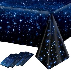 a table cloth with blue stars on it and two napkins next to the table