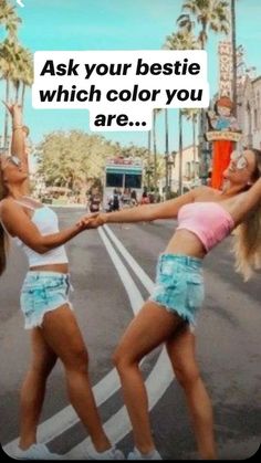 two women are dancing on the street with palm trees in the background