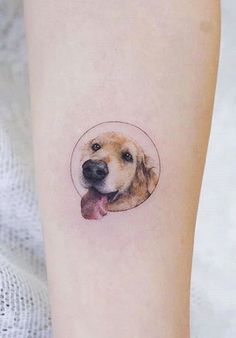 a dog with a bone in its mouth tattoo on the left inner forearm and leg