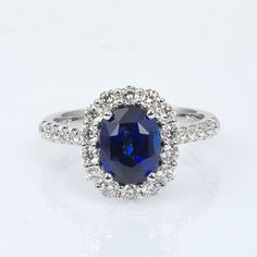 This natural Sri Lankan Sapphire has a deep unmatched royal blue color. Cut to maximize its color from the rough, this oval gem has been set amongst diamonds to bring just the right amount of brightness to the ring. It’s the perfect ring to pop the big question. Order online info@jupitergem.com Luxury Sapphire Ring In Sterling Silver With Prong Setting, Luxury Sapphire Diamond Ring With Round Cut, Luxury Sapphire Diamond Ring With Prong Setting, Luxury Sapphire Diamond Solitaire Ring, Classic Luxury Sapphire Ring With Single Cut Diamonds, Luxury Round Cut Sapphire Ring For Formal Events, Luxury Classic Sapphire Ring With Round Cut, Luxury Solitaire Sapphire Ring For Formal Occasions, Luxury Classic Round Cut Sapphire Ring