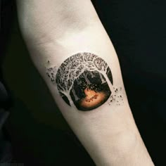 a person's arm with a tattoo on it that has an image of a forest