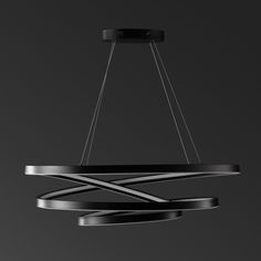 a modern chandelier hanging from the ceiling in black and silver tones with an abstract design