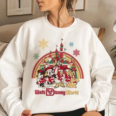 Disney Letter Print Sweatshirt For Winter, Disney Sweatshirt For Winter Fan Events, Casual Winter Sweatshirt For Disney Fan Events, Holiday Crew Neck Top With Character Print, Holiday Disney Crew Neck T-shirt, Disney Crew Neck T-shirt For Holiday, Disney Holiday Crew Neck T-shirt, White Disney Long Sleeve Sweatshirt, White Crew Neck Top For Disney Trips