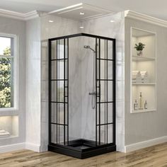 a corner shower stall in a white and black bathroom