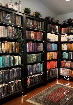 a room filled with lots of books on top of wooden shelves next to a rug