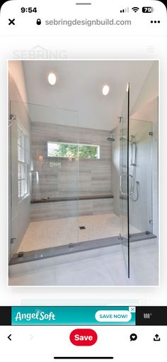 a bathroom with a walk in shower next to a window