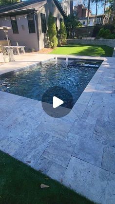 a backyard with a swimming pool surrounded by grass