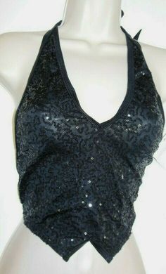 a mannequin wearing a black top with sequins on it