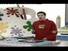 a man standing in front of a table with paint and crayons on it