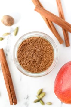 an apple and cinnamon spice on a white surface next to the ingredients for this recipe