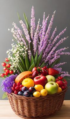 a wicker basket filled with lots of fresh fruit and flowers on a wooden table