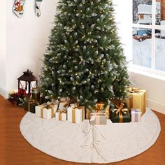 a decorated christmas tree with presents under it