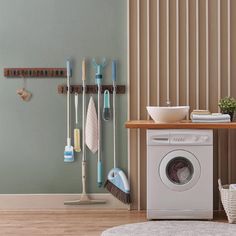 a washer and dryer in a room with wall hangings on the walls