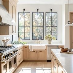 a large kitchen with wooden cabinets and white counter tops, along with an island in the middle