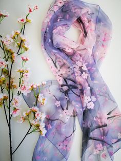 Cherry blossoms after winter Subtle Hand painted on Silk Chiffon. Wrap yourself or your beloved with a sakura tree branch and lots of light pink small blossoms. It's a fresh early spring sense in a soft dusty purple sky. This design Scarf is MADE TO ORDER and available in 2 SQUARE and 5 OBLONG sizes: 21*x21 inches (55x55cm)- Very small square. Can serve as a kerchief; wrist, head or bag band. 35*35 inches (90*90cm) -Possible various combinations of twisting on neck/chest. XS---59x15 inches (150x Spring Floral Print Scarves As Gifts, Pink Silk Shawl For Spring, Pink Shawl Scarf For Spring, Pink Shawl Scarves For Spring, Purple Silk Scarf With Floral Print For Spring, Purple Floral Print Silk Scarf For Spring, Purple Silk Scarves For Spring, Artistic Floral Print Scarves For Spring, Pink Scarf For Spring Gift