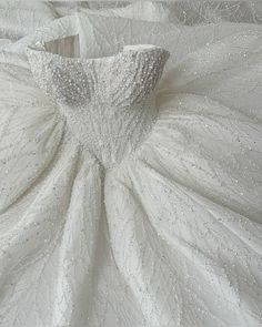 the back of a wedding dress with beading on it