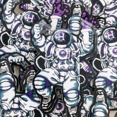 a bunch of stickers that are on the side of a wall with purple and white designs