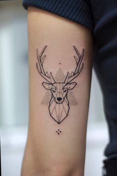 a deer head tattoo on the arm