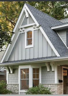 a house with gray shingles and white trim