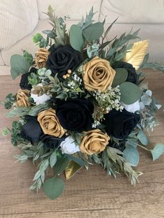 a bridal bouquet with black and gold flowers