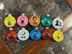 a group of christmas ornaments sitting on top of a marble floor next to a wooden door