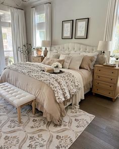 a large bed sitting in a bedroom on top of a wooden floor next to a window