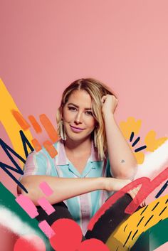 a woman sitting on top of a chair with her hands behind her head and colorful shapes in the background