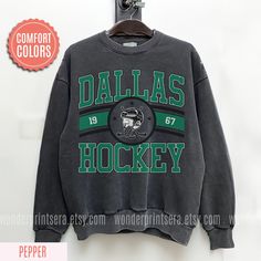 a sweatshirt hanging on a wall with the words dallas hockey printed on it