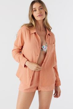 Lightweight woven longsleeve top that has a front button design with collar, soft feel and solid color wash. O'Neill Women's woven top Regular length For an oversized look, we suggest sizing up Front button closure with collar Solid color wash 100% Cotton Crinkle Double Gauze Orange Beach Tops With Button Closure, Long Sleeve Summer Blouse, Summer Long Sleeve Cotton Blouse, Summer Long Sleeve Loungewear Shirt, Long Sleeve Summer Loungewear Shirt, Summer Long Sleeve Shirt For Loungewear, Summer Long Sleeve Shirt With Button Closure, Long Sleeve Shirt For Summer Loungewear, Long Sleeve Beach Shirt