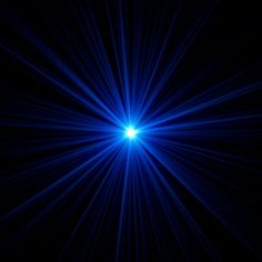 a bright blue light shines brightly in the night sky, creating a star burst