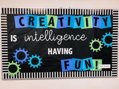 a bulletin board with the words creativity is inteliligence having fun written on it