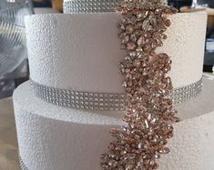 a three tiered wedding cake decorated with crystals