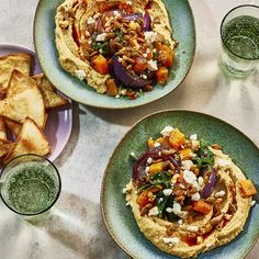 three plates filled with different types of food on top of a table next to drinks