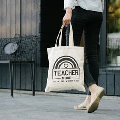 a woman carrying a bag that says teacher mode