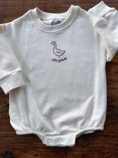 This high quality personalized sweatshirt is the perfect thing for back to school and cooler weather! Great as a gift for the silliest goose in your life! All work is done by hand, so some variation is expected in your custom piece. Cozy, warm, and cute, these are ideal for your little ones! New Baby Embroidery Boy, Embroidered Monthly Milestone, Embroidery On Baby Onsie, Onsie Embroidery Ideas, Embroidered Baby Clothes Boys, Baby Boy Embroidery Ideas, Boy Embroidery Ideas, Boys Embroidery Designs, Embroidery Baby Gifts