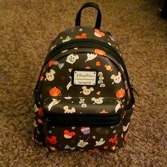 Nwt Disney Parks Loungefly Snacks Mini Backpack. As The Spooky Season Approaches This Bag Will Bring Out The Halloween Spirit With Spooky Ghosts And Mickey Head Snacks. Inside You Will Find Candy Lining In The Backpack. Note First Image Is For Reference Of What The Bag Looks Like Held Up, But Is Not The Same Print Placement As The Bag For Sale. Actual Bag Is In 3rd Picture. Please Reference The 3rd Pic For Placement Reference. Check Out My Closet For Other Items. Bundle To Save! Fun Black Standard Backpack, Black Disney Bag For Theme Park, Black Disney-style Bag For Theme Park, Black Disney Style Bag For Theme Park, Themed Black Backpack For Theme Parks, Black Backpack For Theme Parks, Black Backpack For Theme Park, Black Disney Backpack For Halloween, Disney Halloween Backpack For Disney Trips