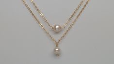 All items ordered 5/14/21 - 5/30/21 will be shipped out on 5/31/21 Our gift to you 10% off your first purchase. Details here - http:/eepurl.com/dpVPBz Tiny pearl necklace. This single pearl hangs from our signature delicate 14 k gold fill or sterling silver chain. Choose pearl drop or link/suspended style for a classic minimal look or use as a great layering piece. Please choose pearl 'drop' or 'link/suspended' style, see picture 3. The pearl is approximately 5 mm wide and is called a potato pea Small Pearl Necklace, Tiny Pearl Necklace, Dainty Necklace Layered, Dainty Pearl Necklace, Wishbone Necklace, Single Pearl Necklace, Pearl Drop Necklace, Black Pearl Necklace, Single Pearl