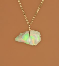 Ethiopian opal necklace - raw opal - genuine opal - natural opal - a raw genuine opal wire wrapped onto a 14k gold vermeil chain - 2B A one of a kind raw ethiopian opal wire wrapped onto a 16 inch 14k gold vermeil chain. Please choose your favorite opal as shown in the fourth photo and a different length chain if you prefer! Also available in sterling silver! Solid 14K yellow and white gold are available for an additional cost. Please message me for details! Need a few reasons to love opal other Bohemian Opal Jewelry Wire Wrapped, Bohemian Opal Wire Wrapped Jewelry, Bohemian Wire Wrapped Opal Jewelry, Wire Wrapped Opal Pendant Necklace, Gold Opal Necklace With Natural Stones, Opal Wire Wrapped Necklace As Gift, Opal Wire Wrapped Necklace For Gift, Gift Opal Necklace With Wire Wrapped Detail, Lavender Opal