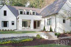 a white house with steps leading to the front door