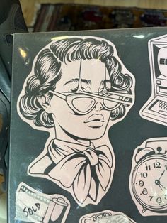 a laptop with stickers on it and an image of a man in glasses next to a clock