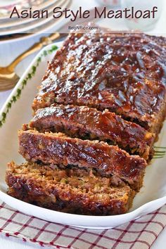 sliced meatloaf in a white dish on a red and white checkered napkin