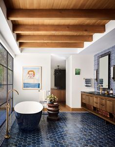 a bathroom with a large tub and wooden ceiling