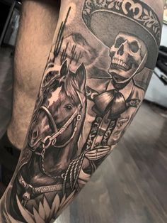 a man's leg with a skull and horse tattoo on it