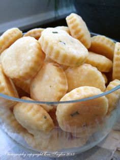 a glass bowl filled with crackers on top of a table