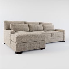 a large sectional couch with pillows on the top and bottom ends, in front of a white background