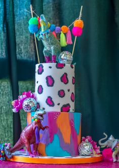 a brightly colored cake decorated with toys and decorations