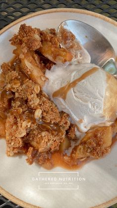 a white plate topped with ice cream and apple crisp pie next to a scoop of vanilla ice cream