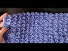 someone is crocheting the edge of a blanket